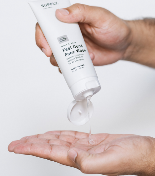 A pair of hands pouring the Supply Co face wash