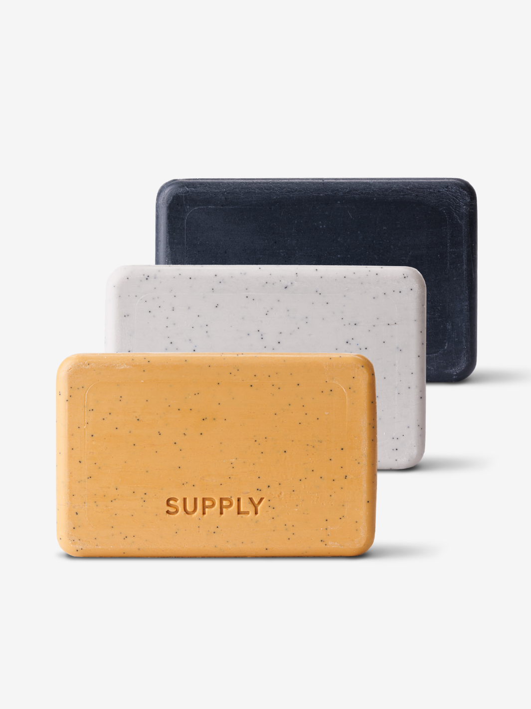 Three rectangular bars of soap in black, white, and orange with 'SUPPLY' imprinted.