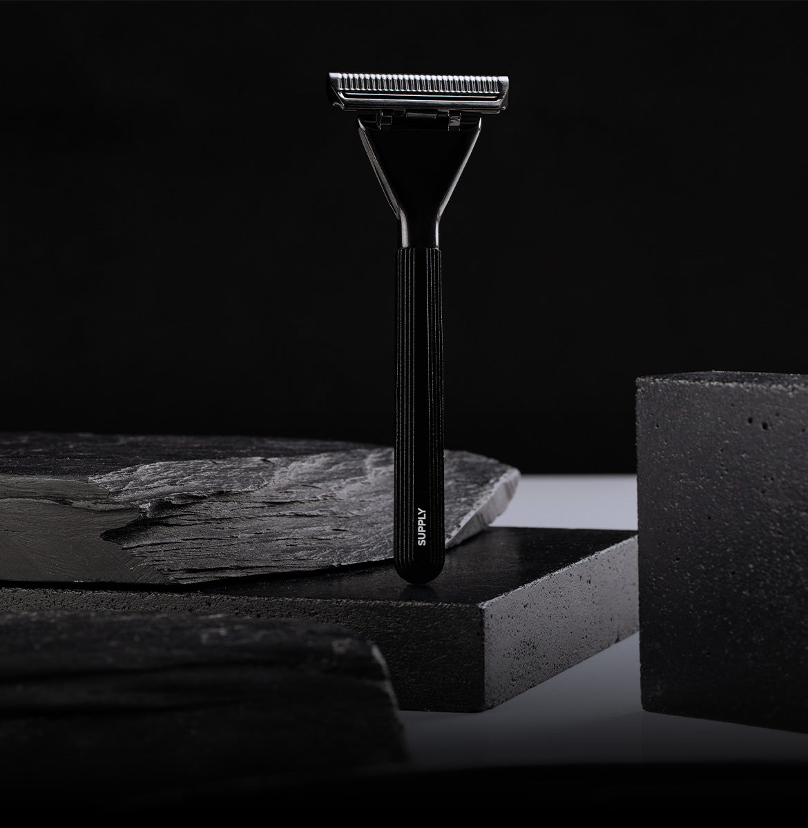 Black safety razor on a dark background