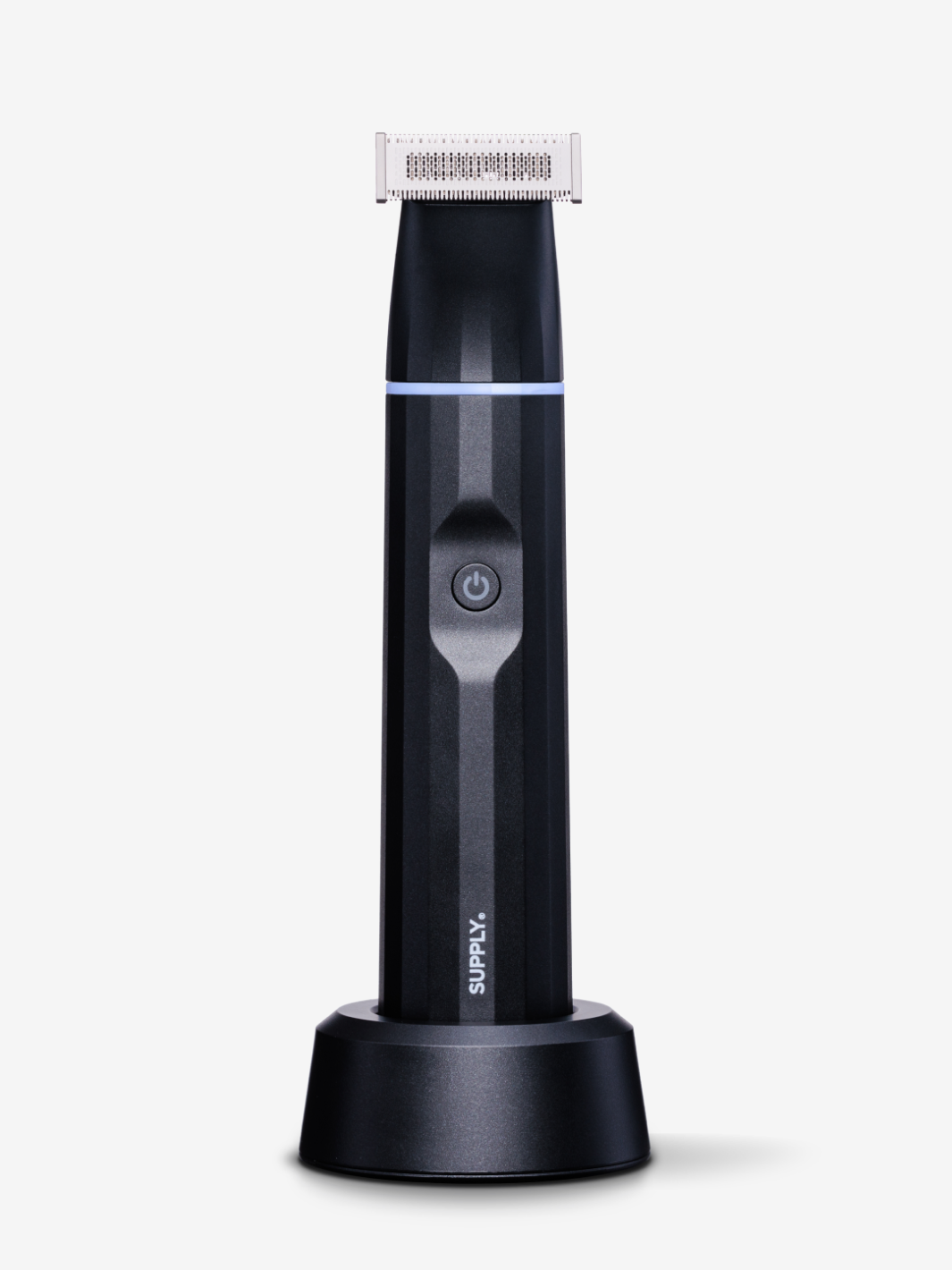 Electric grooming trimmer with charging stand against white background.