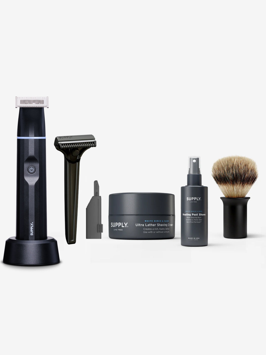 Men's grooming set with electric trimmer, razor, shaving cream, aftershave, and brush.