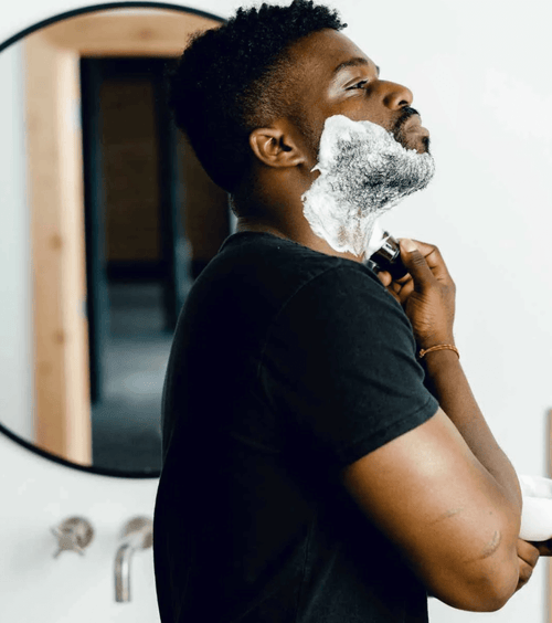 A man applying the supply shaving cream using the silvertip synthetic brush