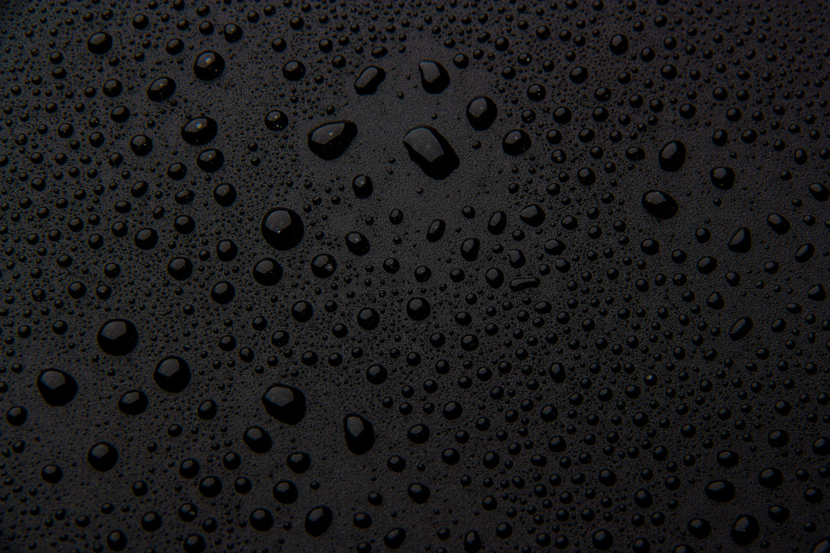 Close-up of water droplets on a black surface