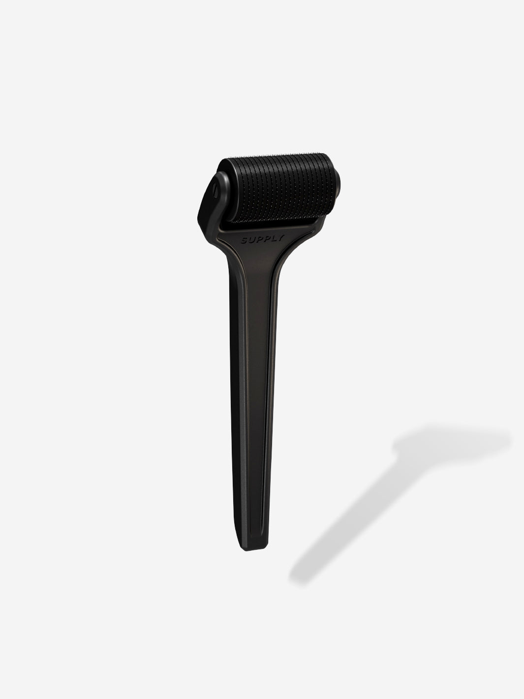 Black derma roller with textured handle on a white background.