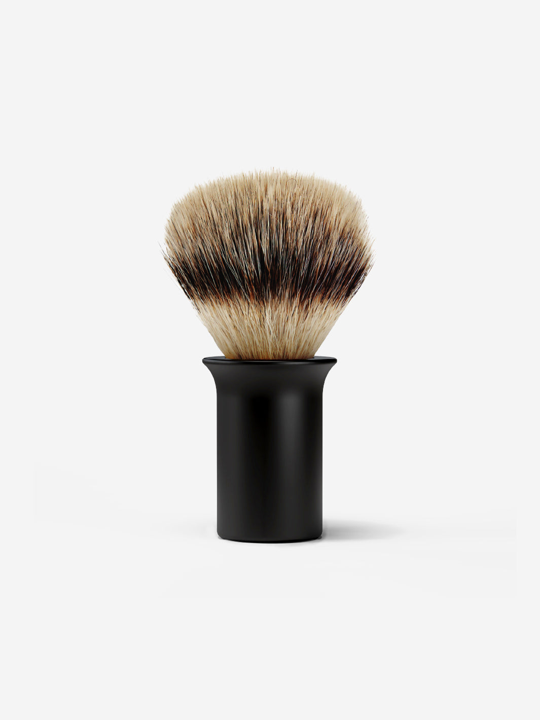 Shaving brush with black handle on a white background.