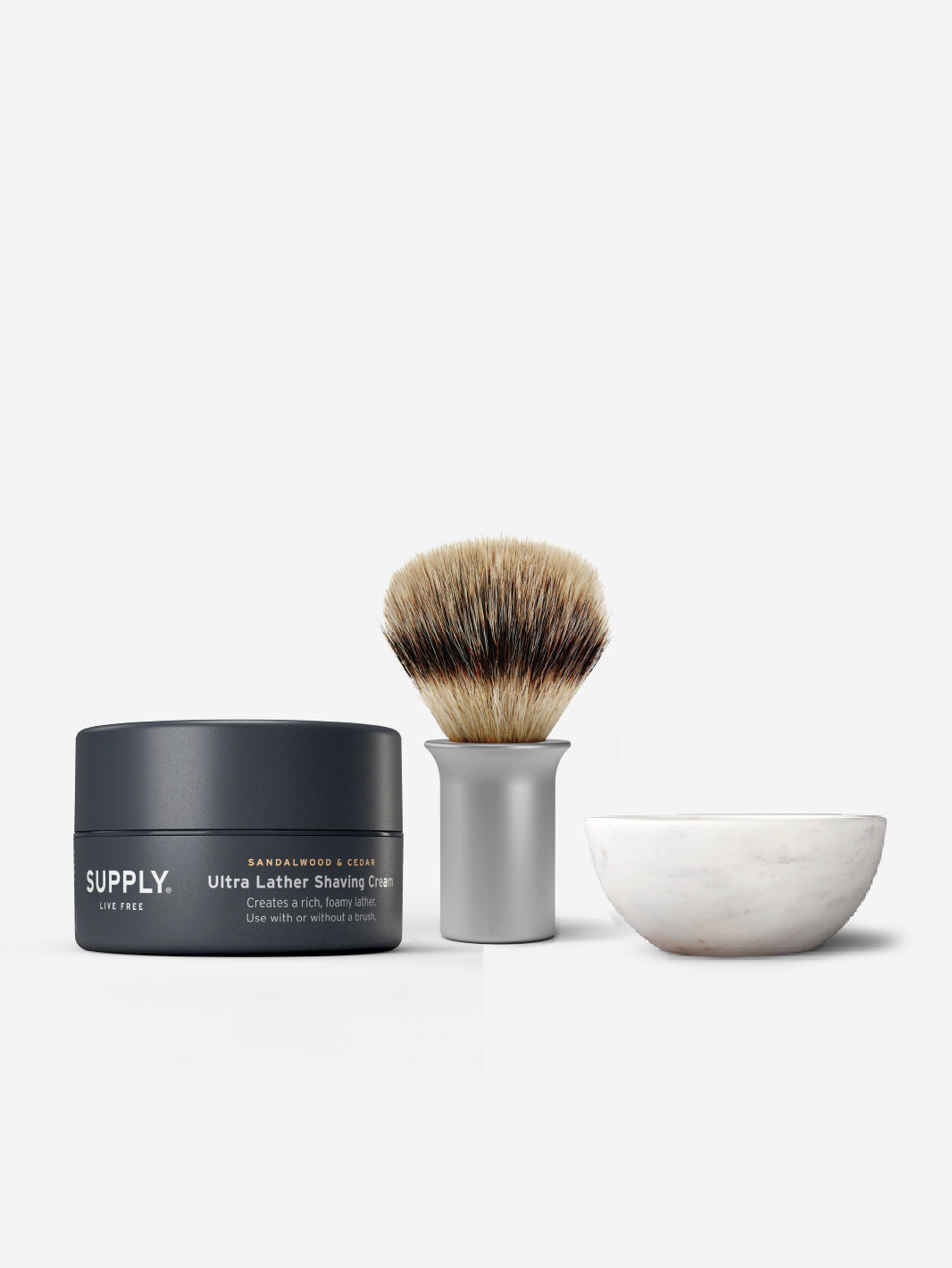 Shaving cream, brush, and bowl set on a white background.